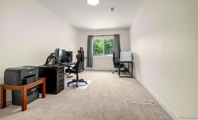 a view of workspace with furniture and a window