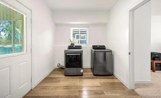 a view of a kitchen with a stove fridge and wooden floor