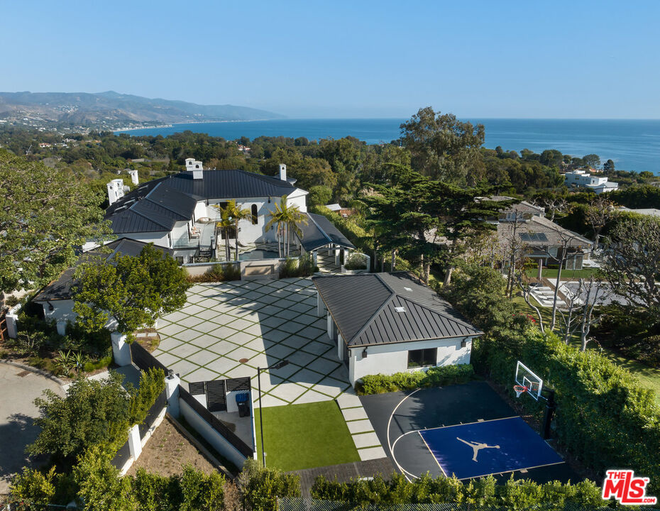7052 Dume Drive Malibu, CA 90265 - Photo 1 of 52 an aerial view of multiple house houses with outdoor space and seating