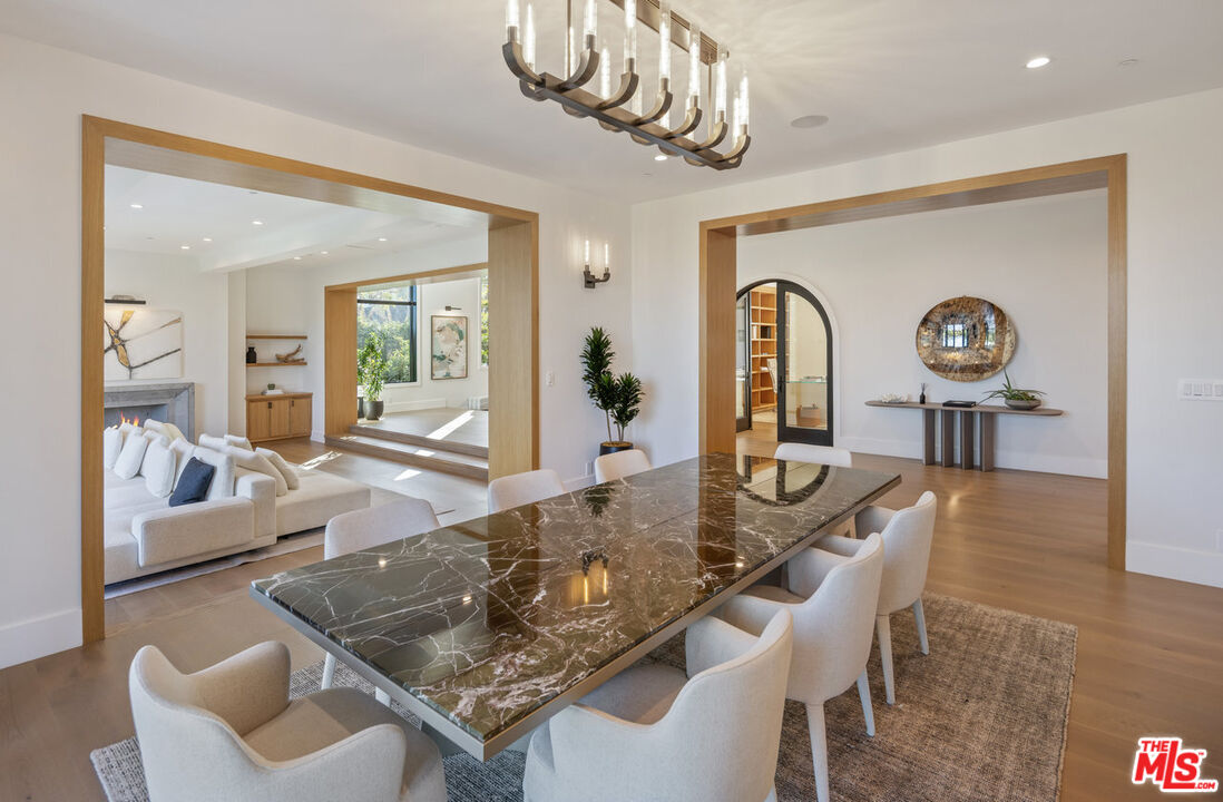 7052 Dume Drive Malibu, CA 90265 - Photo 16 of 52 a living room with furniture and a chandelier