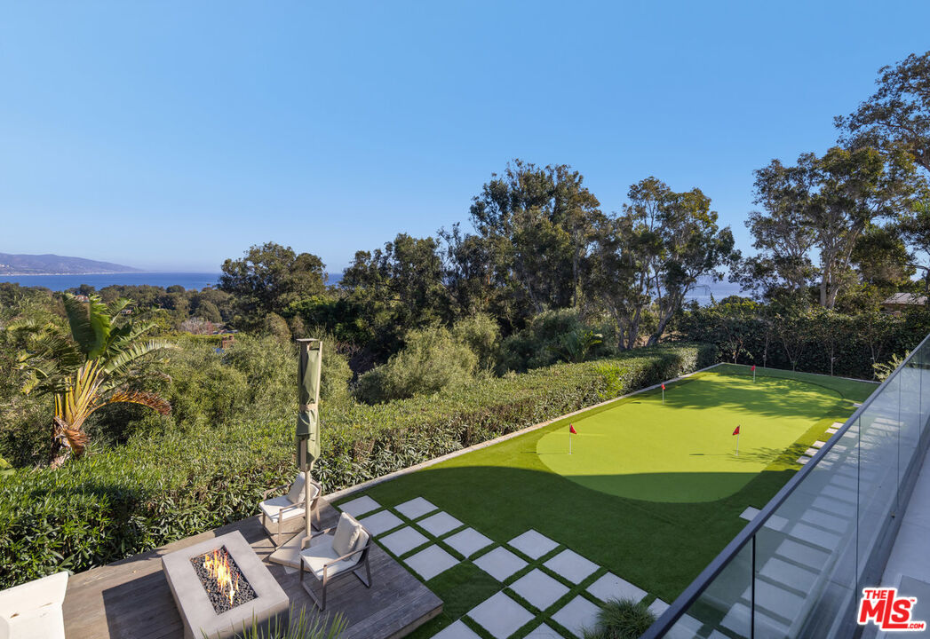 7052 Dume Drive Malibu, CA 90265 - Photo 18 of 52 a view of a pool with a patio