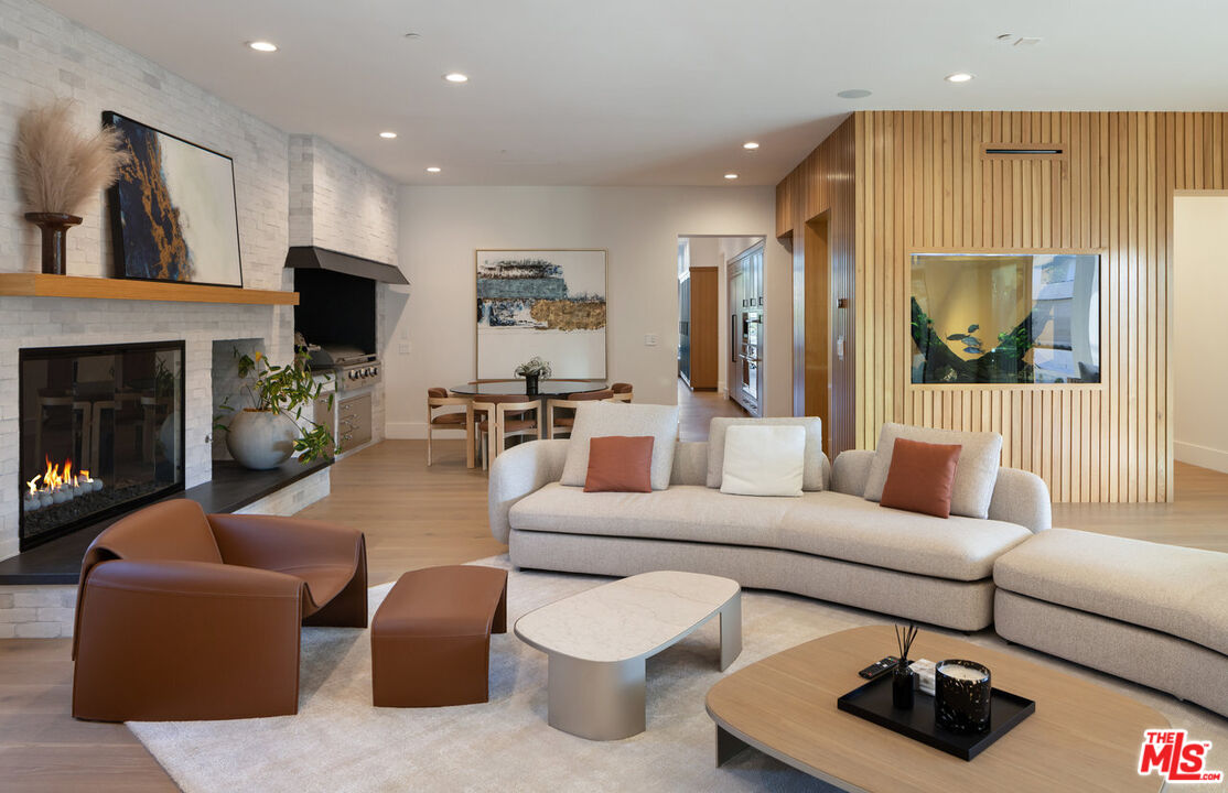7052 Dume Drive Malibu, CA 90265 - Photo 27 of 52 a living room with furniture a flat screen tv and a fireplace