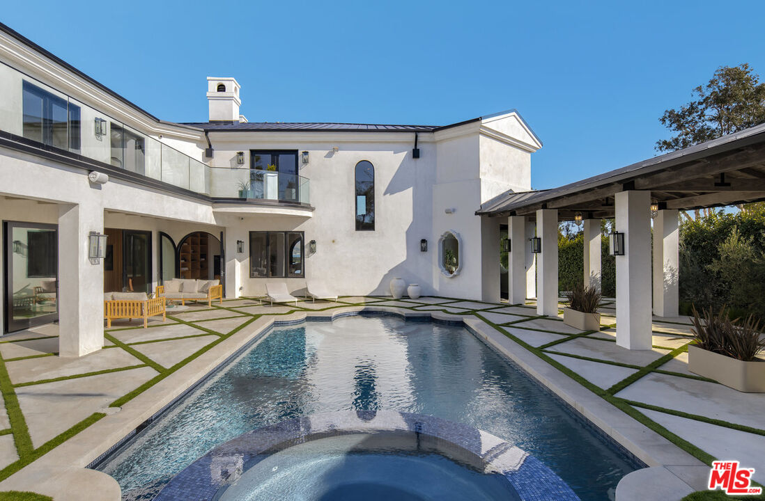 7052 Dume Drive Malibu, CA 90265 - Photo 3 of 52 a view of a house with pool and sitting area