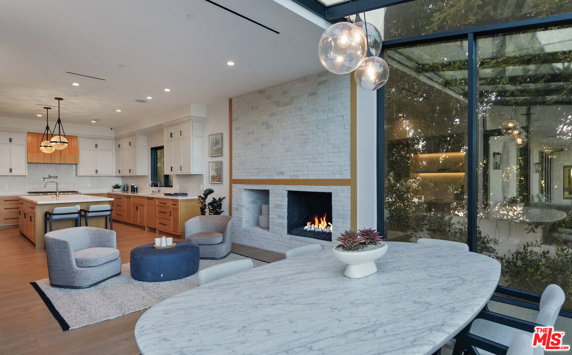 7052 Dume Drive Malibu, CA 90265 - Photo 33 of 52 a kitchen with a sink and a fireplace