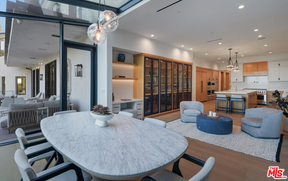 7052 Dume Drive Malibu, CA 90265 - Photo 34 of 52 a dining room with furniture a table and chairs
