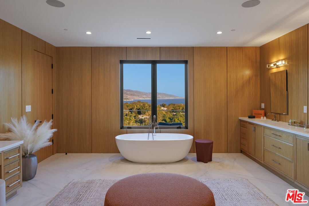 7052 Dume Drive Malibu, CA 90265 - Photo 40 of 52 a spacious bathroom with a large tub and shower