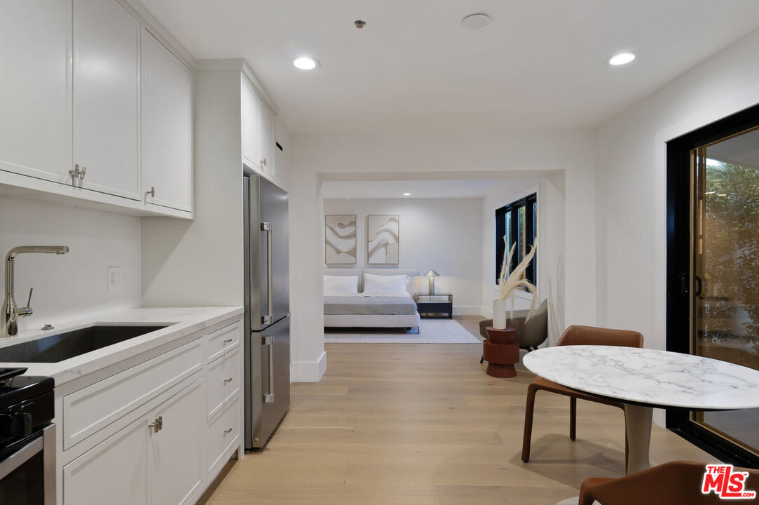 7052 Dume Drive Malibu, CA 90265 - Photo 45 of 52 a spacious bedroom with a bed a couch and a view of living room