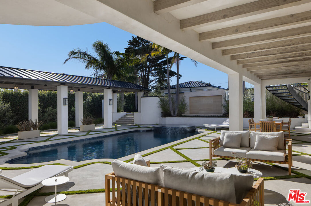 7052 Dume Drive Malibu, CA 90265 - Photo 6 of 52 a view of a house with swimming pool and porch with furniture