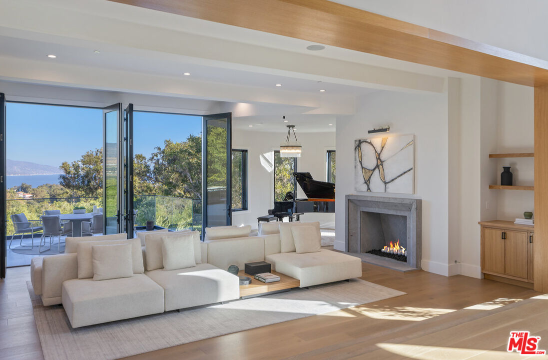 7052 Dume Drive Malibu, CA 90265 - Photo 7 of 52 a living room with furniture and a fireplace