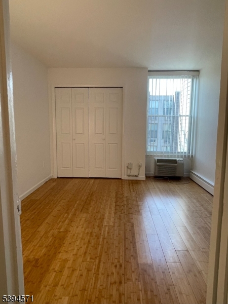 6 River Road, Unit K Nutley, NJ 07110 - Photo 12 of 21 an empty room with wooden floor and windows