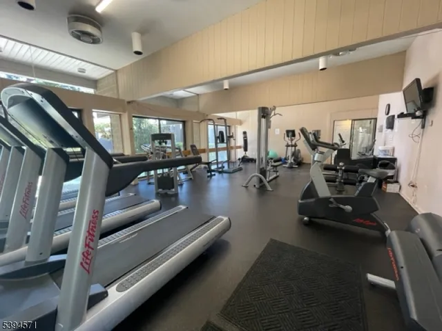 a gym room with lots of gym equipment