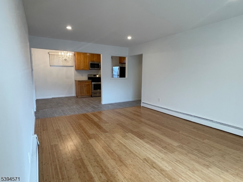 6 River Road, Unit K Nutley, NJ 07110 - Photo 2 of 21 wooden floor in an empty room with a window