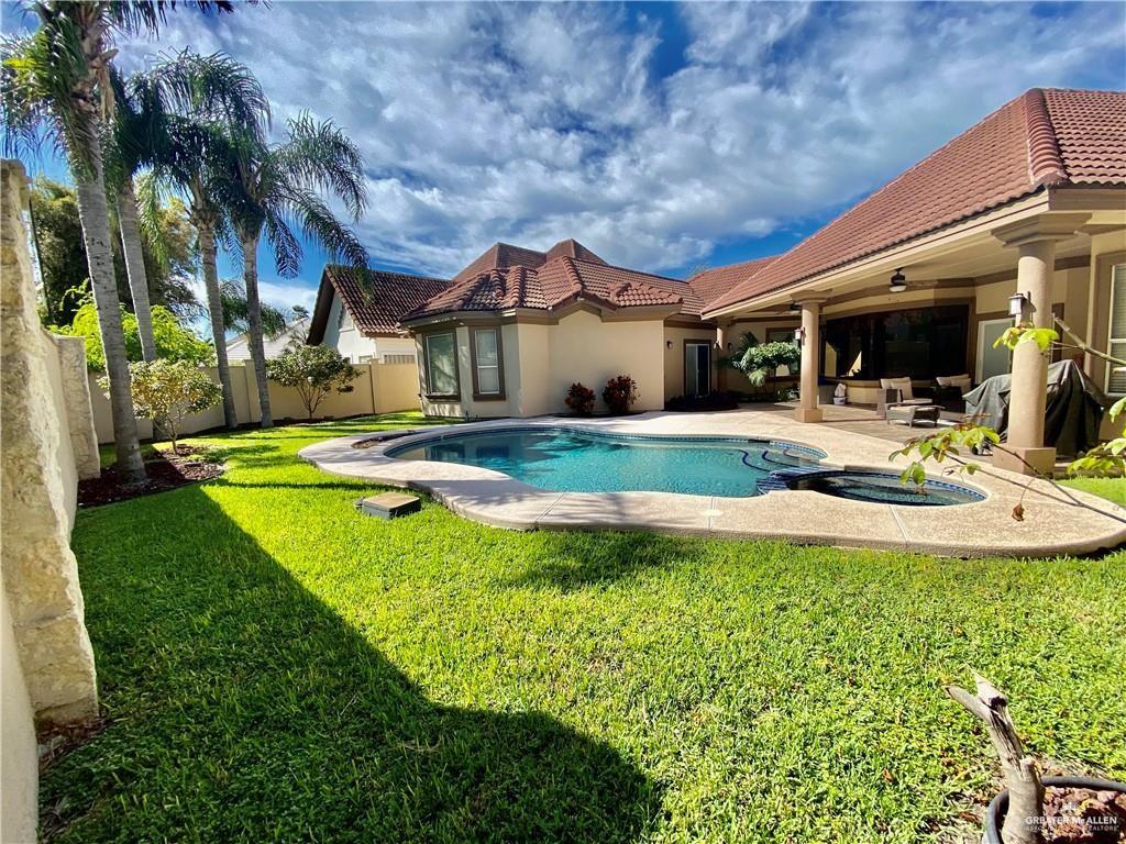 7408 North 5th Street McAllen, TX 78504 - Photo 2 of 4 a view of a house with swimming pool and a yard