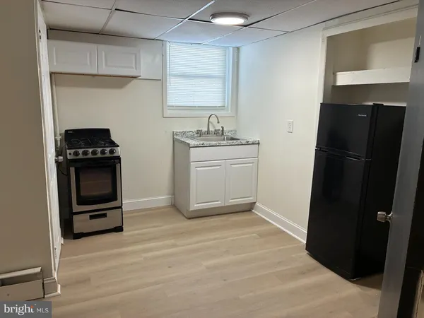 a kitchen with a sink stove and refrigerator