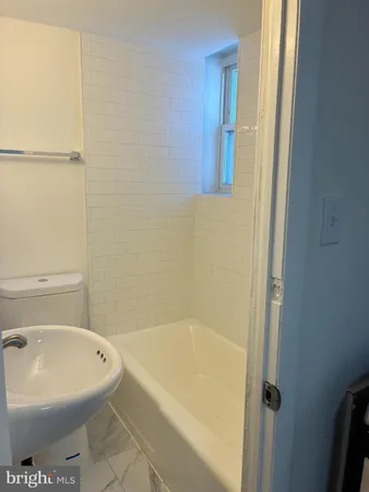a white bath tub sitting next to a white toilet