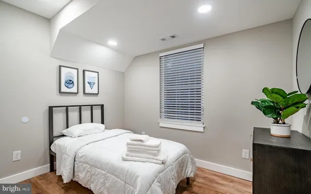 a bedroom with a bed and a window