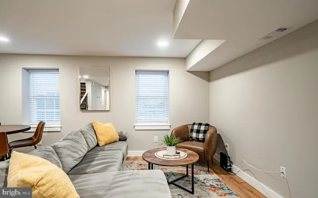a living room with furniture and a potted plant
