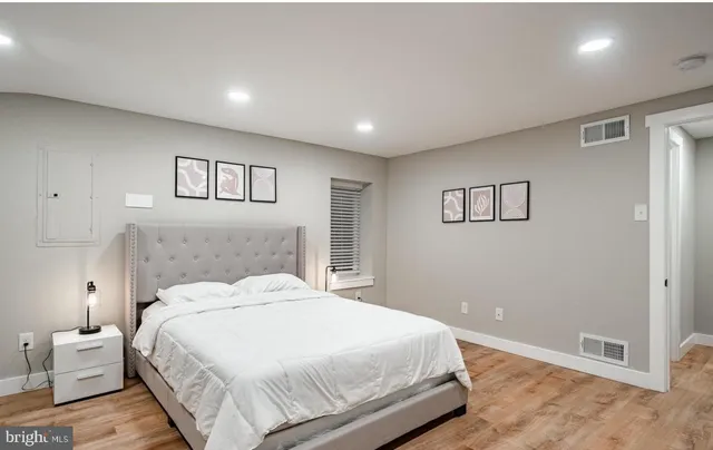 a bedroom with a bed and a night stand