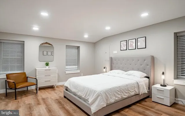 a spacious bedroom with a bed and a desk