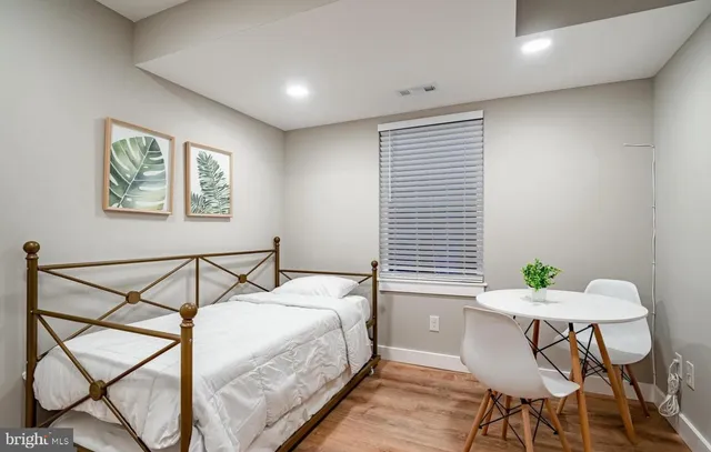 a bedroom with a bed and table