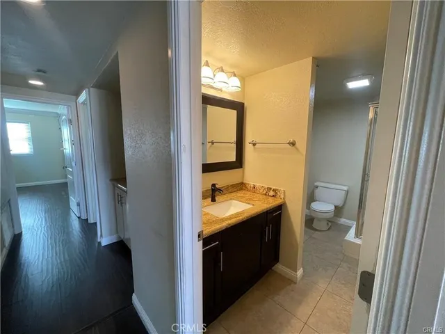 a view of hallway with stairs and wooden floor