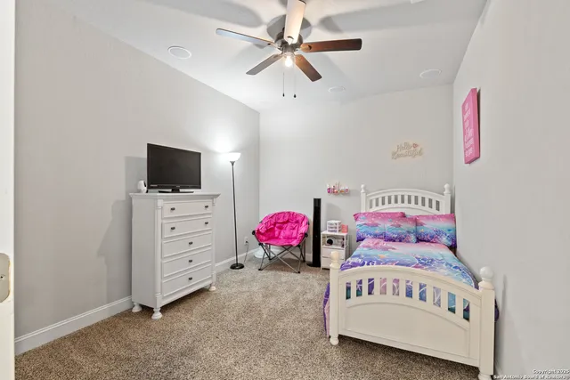 a bedroom with furniture and a flat screen tv