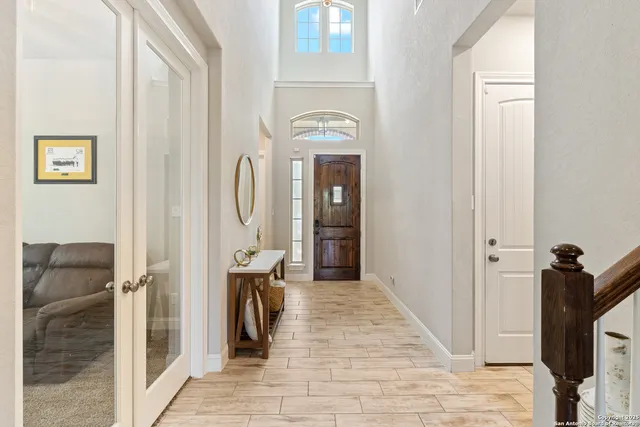 a view of a hallway with entryway dining room and hall with wooden floor