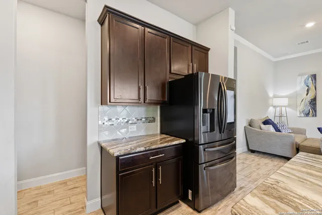 a kitchen with stainless steel appliances granite countertop a refrigerator stove and oven