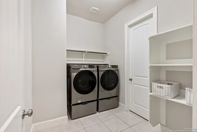 a utility room with sink dryer and washer