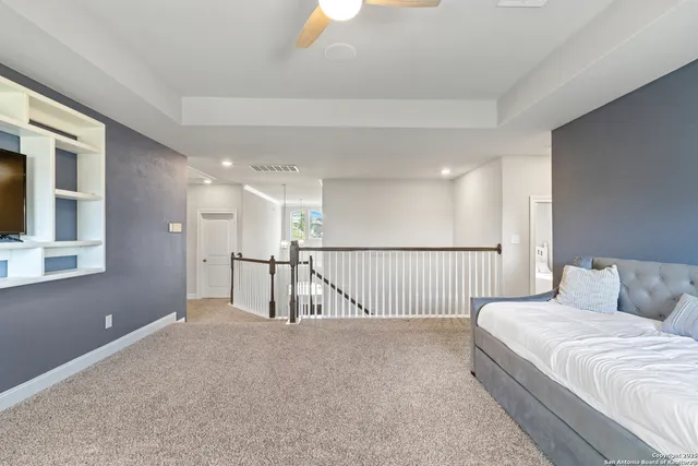 a view of a bedroom with wooden floor