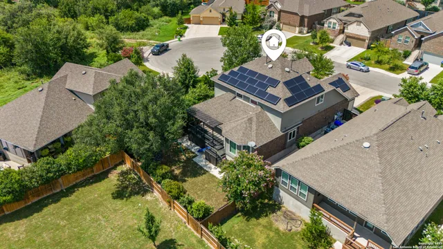 an aerial view of a house with a yard and potted plants