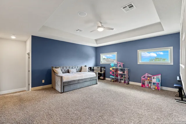 a bed room with furniture and a flat screen tv
