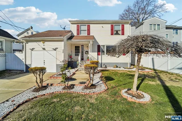 a view of a house with backyard and a patio