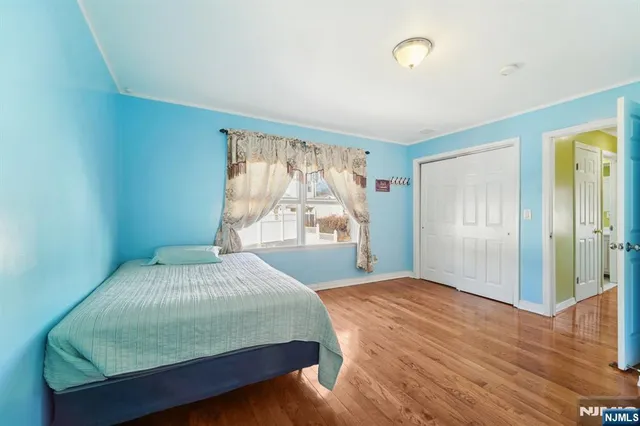 a bedroom with a large bed and a large window