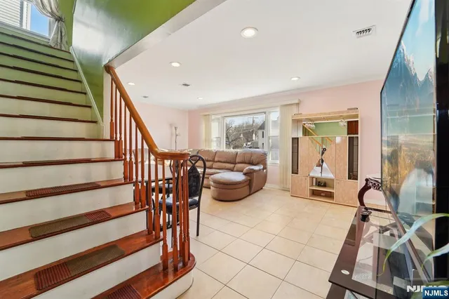 a view of a livingroom with furniture and staircase