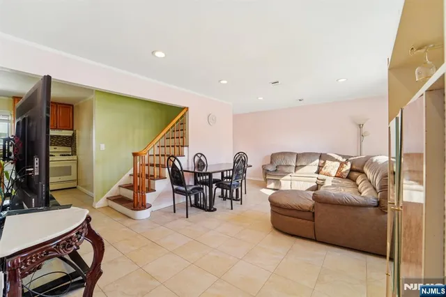 a living room with furniture a rug and white walls