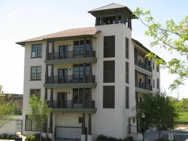 a front view of a building with a garden