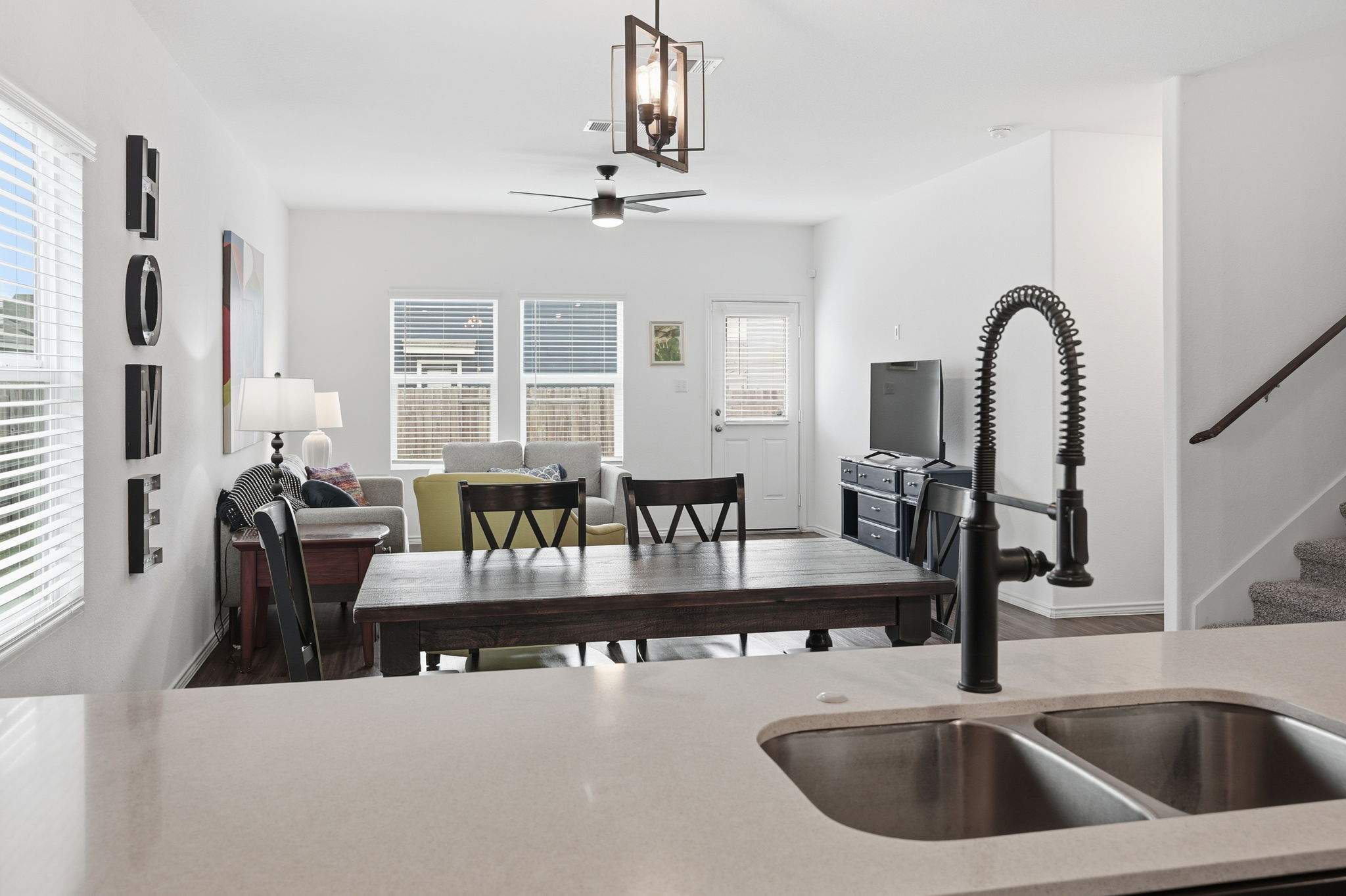 1200 Rio Frio Lane Georgetown, TX 78626 - Photo 12 of 25 Kitchen featuring ceiling fan, wood finished floors, light stone countertops, and hanging light fixtures