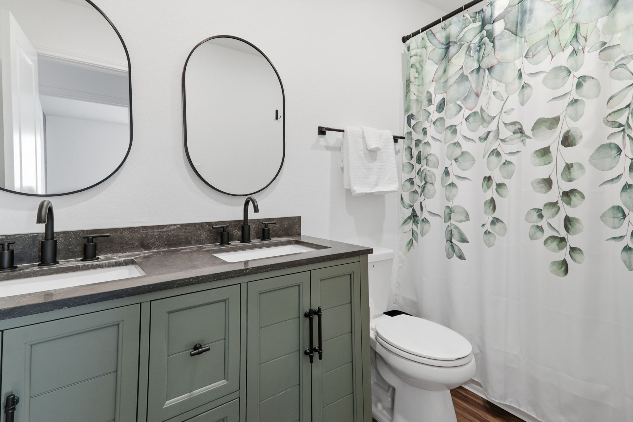 1200 Rio Frio Lane Georgetown, TX 78626 - Photo 23 of 25 Bathroom featuring double vanity, a shower with curtain, and dark wood-style floors
