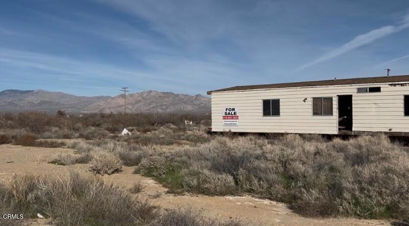 91525 Palm Road Baker, CA 92309 - Photo 19 of 39 a view of a house with a yard