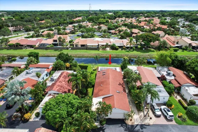 an aerial view of residential houses with outdoor space and trees