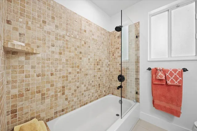a bathroom with a bathtub and shower