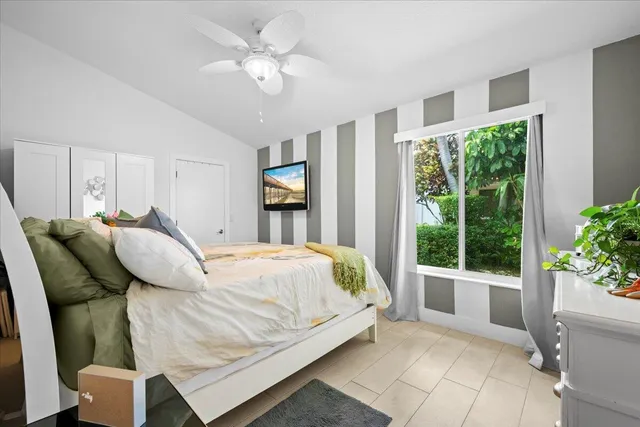 a bedroom with a bed and glass window