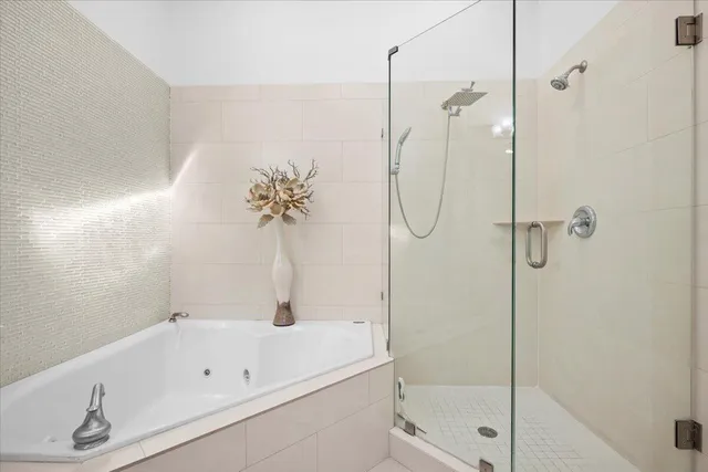 a bathroom with a tub and a shower