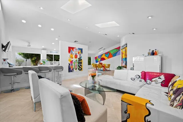 a living room with furniture and kitchen view