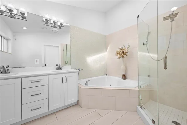 a view of a patio with plants and palm trees