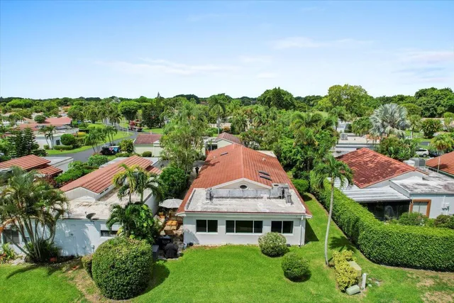 an aerial view of a house with a garden and trees