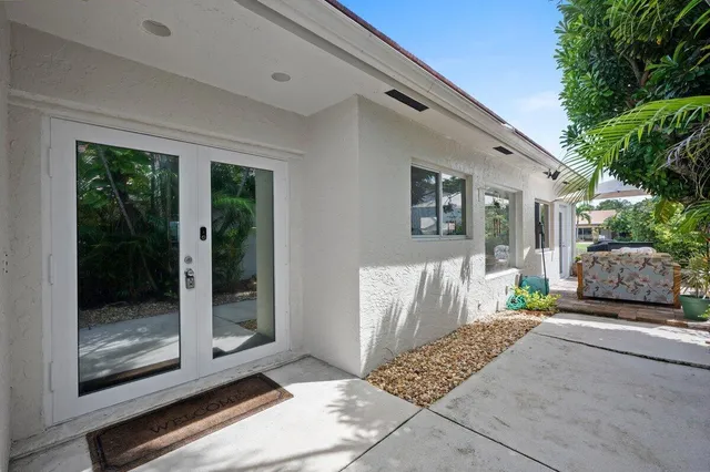 a view of a patio with furniture and a garden