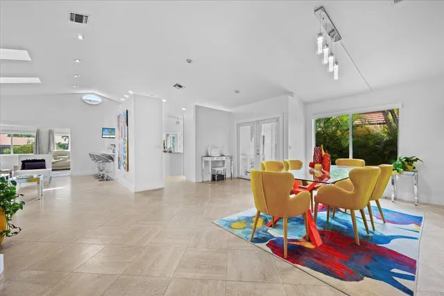 a living room with furniture and a floor to ceiling window