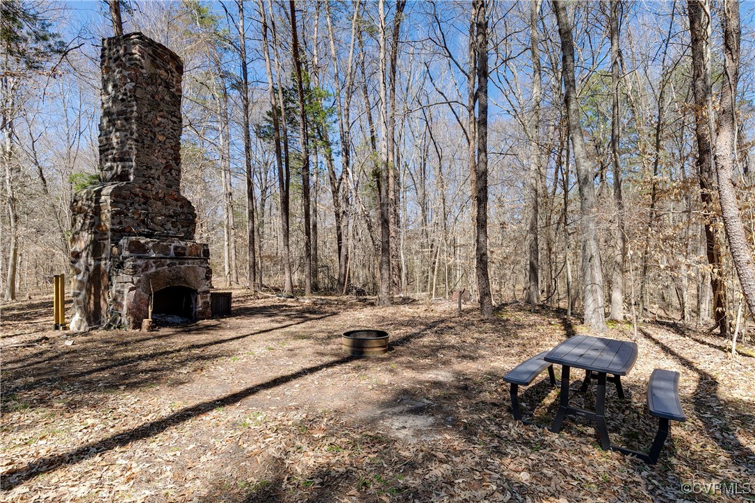 14 Ca Ira Road Cumberland, VA 23040 - Photo 32 of 43 a backyard of a house with table and chairs and a fire pit